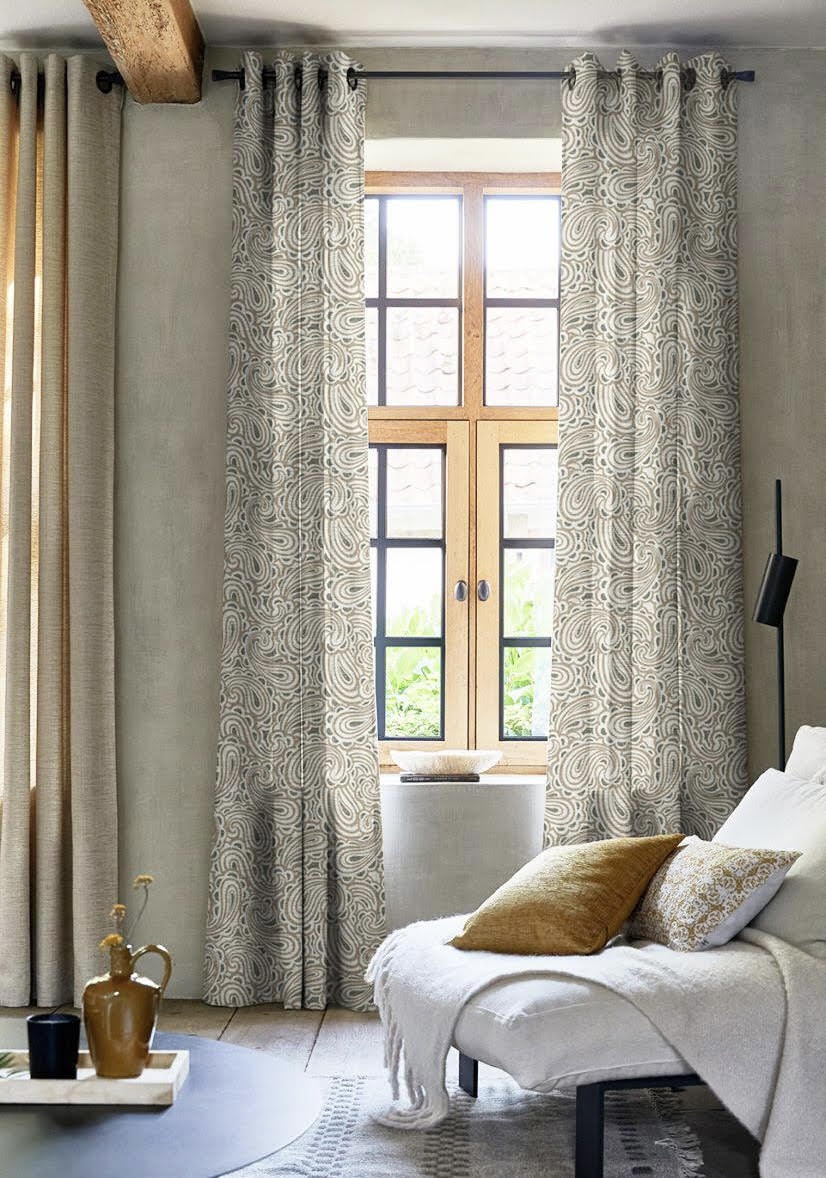 Paisley-pattern grommet drapes layered over a wood French door