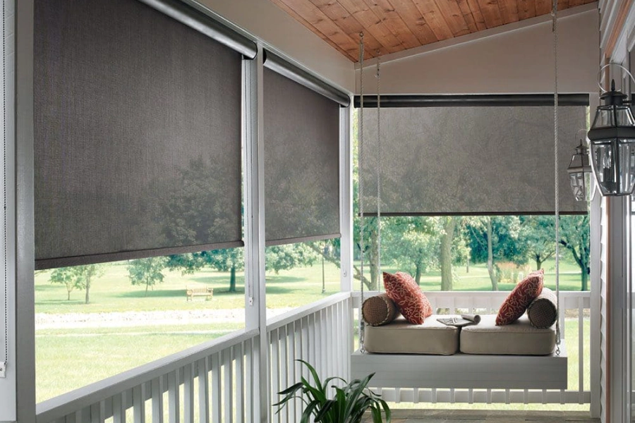 Dark roller shades on a covered Texas porch with a daybed
